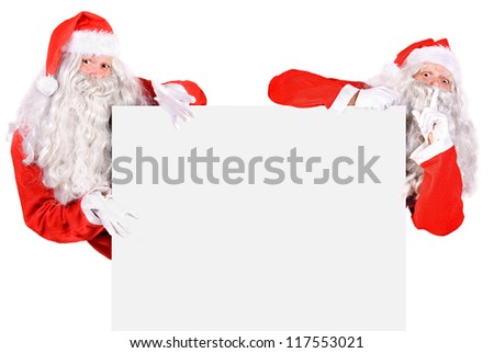 Two Santa Claus holding a blank sign isolated on white background