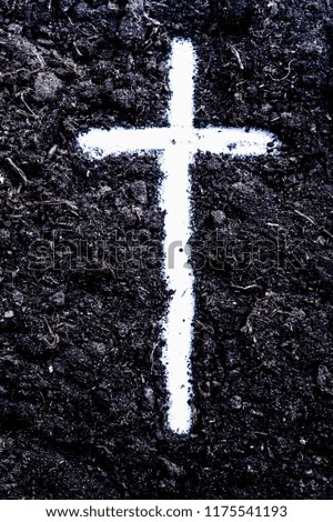 The silhouette of cross against of soil background. The cross as symbol for Jesus Christ. Christianity, religion, faith concept.