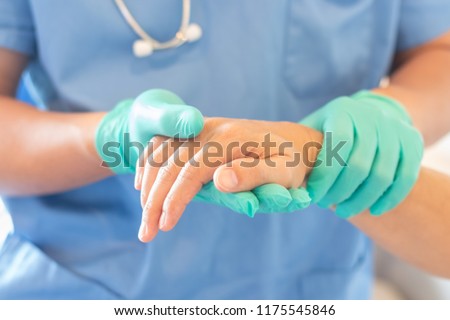 Surgeon, surgical doctor, anesthetist or anesthesiologist holding patient's hand for health care trust and support in ER professional surgical operation, medical anesthetic safety, healthcare concept Royalty-Free Stock Photo #1175545846