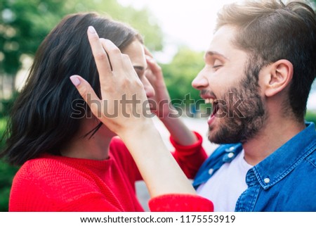 Always be with you. Beautiful smiling couple in love are walking together. Woman and man are hugging, kissing and have a fun together in park outdoors