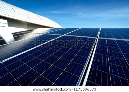 Solar panel on blue sky background. Roof and cloudy sky. Alternative energy concept.