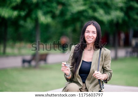 Happy woman walking in european street. Portrait of young attractive tourist outdoors
