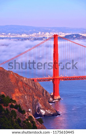 Fog covers the Golden Gate Bridge at sunset, CA-USA