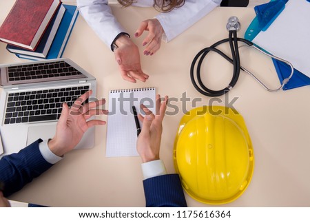 Doctor and manager agreeing industrial insurance coverage Royalty-Free Stock Photo #1175616364