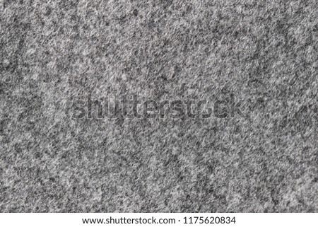 Natural dark gray color of felt abstract background. Surface of felted fabric texture.High resolution photo.

