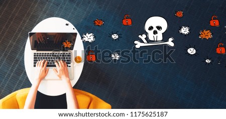 Virus and scam theme with person using a laptop on a white table