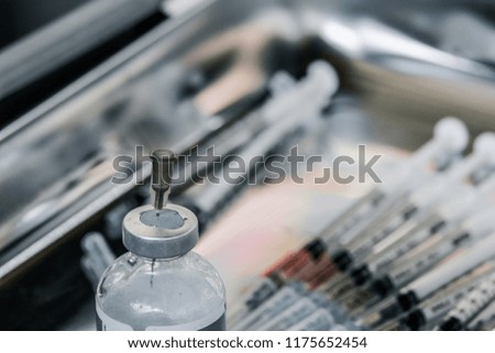 needle with vial preparation for draw liquid into syringe , blur syringes background