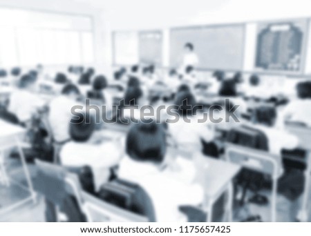 Blurred picture gray tone background of student during study or exams by teacher in classroom primary school.