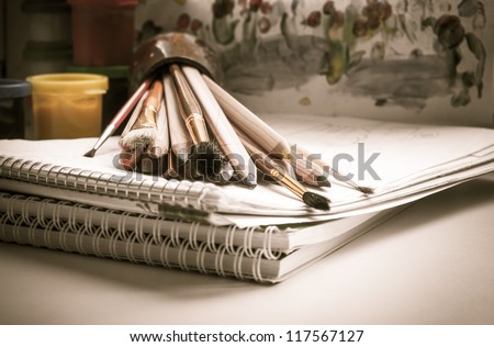 Colored pencils, paint, sketch pad, drawing, brush Royalty-Free Stock Photo #117567127