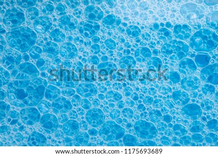 abstract background texture of blue soap foam closeup