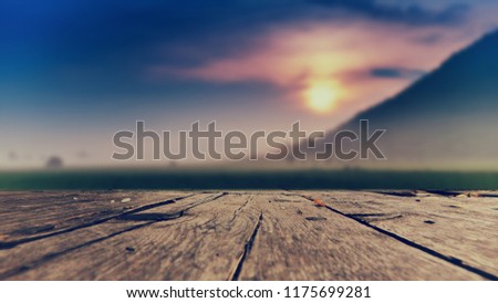 Halloween background concept, wooden floor on sunset and mountain selective focus and dark color effect.