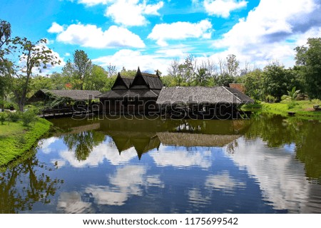 Thai style house with garden and sky backdrop.