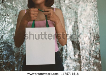 Shopper woman hand shopping with  carrying bag background boken