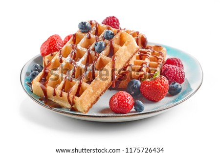 plate of waffles decorated with chocolat sauce and fresh berries isolated on white background Royalty-Free Stock Photo #1175726434