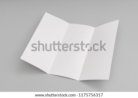 Trifold white template paper on blue background.