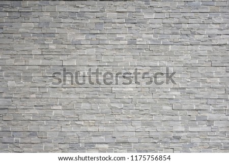 Strong natural gray brick stone wall background or texture. Pattern of black slate wall . Norway. Modern pattern of decorative slate stone wall Surface. Granite stone decorative brick wall seamless.