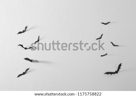 Halloween Black paper bats flying over wall white background, Decoration Concept Free space as you design, natural light