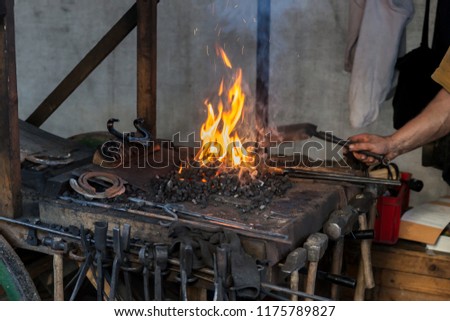 Historic blacksmith shop with the flame in the background
