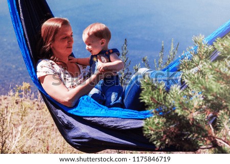 Mom and son in a hammock in the nature