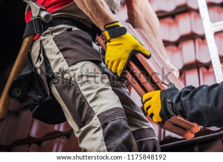 Ceramic Roof Tiles Installation by Two Caucasian Roofers. Construction Industry.

 Royalty-Free Stock Photo #1175848192