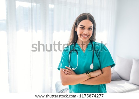 Portrait of an attractive young female doctor or nurse with stethoscope. Portrait of a health professional, nurse. Young female medical worker. Confident nursing or medical student