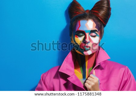 Model with a creative pop art make-up on her face in image of cartoon or comics character