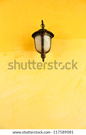 Lantern on a yellow wall