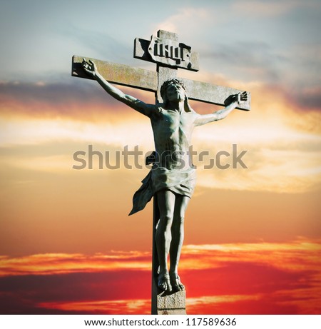 Crucifixion of Jesus Christ on the sunset in the sky