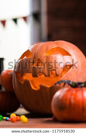 Happy Halloween. Background in front of a window with pumpkins, lantern, spiders and other symbols of a terrible holiday