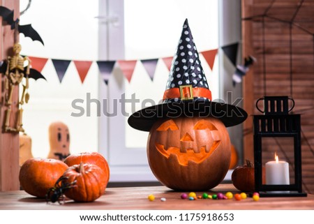 Happy Halloween. Background in front of a window with pumpkins, lantern, spiders and other symbols of a terrible holiday