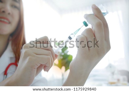 Medical hands and syringes are being vaccinated to patients in the lab.