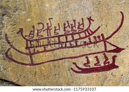 Viking ship, outdoor red stone carving in Tanum, Sweden