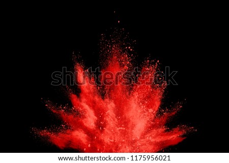 Red particles explosion on black  background. Colorful dust splatter on black background.