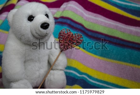 a beautiful white bear with red heart in the paw