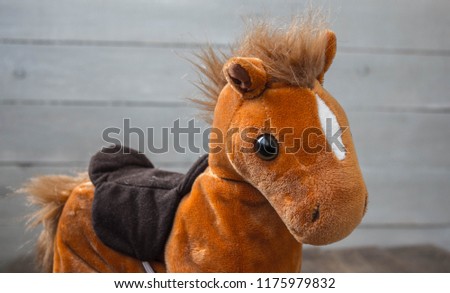 a beautiful red horse with a saddle kid toy