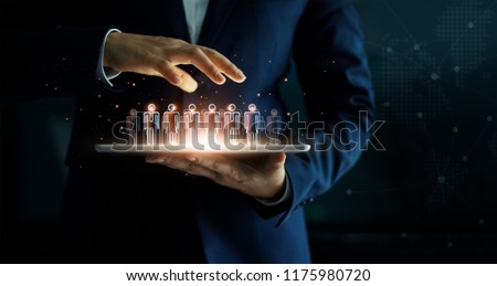 
Businessman holding tablet and management group of people in his hand. Virtual icon of social network. Business technology concept. Royalty-Free Stock Photo #1175980720