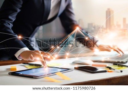 Businessman touching tablet and laptop. Management global structure networking and data exchanges customer connection on workplace. Business technology and digital marketing network concept. Royalty-Free Stock Photo #1175980726