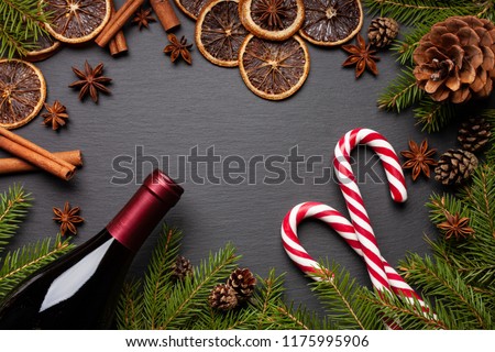 Christmas tree branches on black background as template for a christmas card