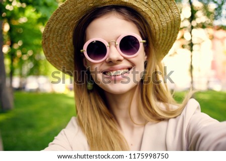 round glasses of a woman in a straw hat on the nature                        