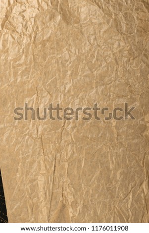 Crumpled Craft Paper Top View with Copy Space for Collages, Design and Montage. Empty Wrinkled Sheet of Brown Wrapping Old Paper Texture with Place for Text