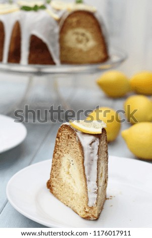 Slice of lemon cream cheese bundt cake with cream cheese filling in the center. Extreme shallow depth of field with selective focus on front of cake.