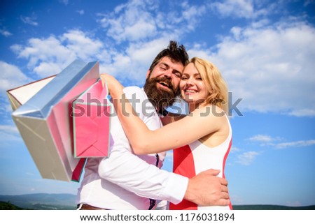 Shopping brings positive emotions. Couple with luxury bags hugs blue sky background. Happy couple luxury purchases. Man beard and girl enjoy shopping together. Family bought excellent clothes.