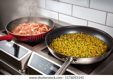 Low peas and pancetta cooked in pan on electric oven
