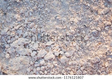 background of crumbs of white stones, top view