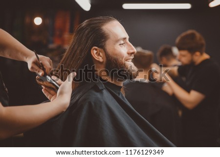 Process of cutting hair with scissors, hairdresser for men.