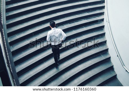 Businessman running fast upstairs Growth up Success concept Royalty-Free Stock Photo #1176160360