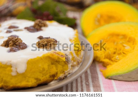 Pumpkin homemade cheesecake with white cream. Autumn still life. Thanksgiving day food.