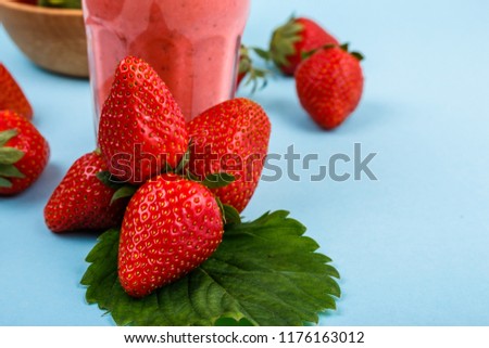 fresh strawberrysmoothie or milkshake on a delicately blue background