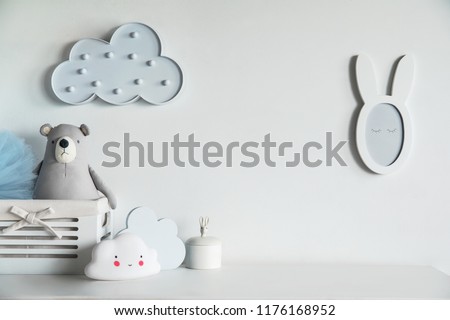 Stylish and cozy childroom with teddy bear, clouds and little mirror Bright and sunny interior.