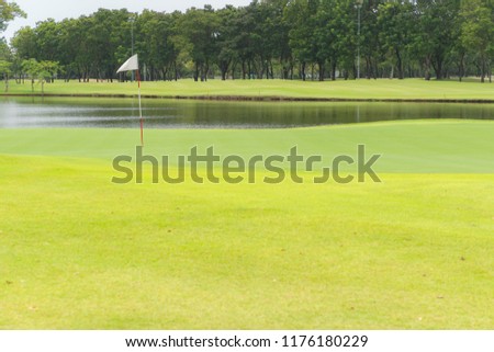 Beautiful golf court and garden, pond or Marsh on white Flag on a hole in one.